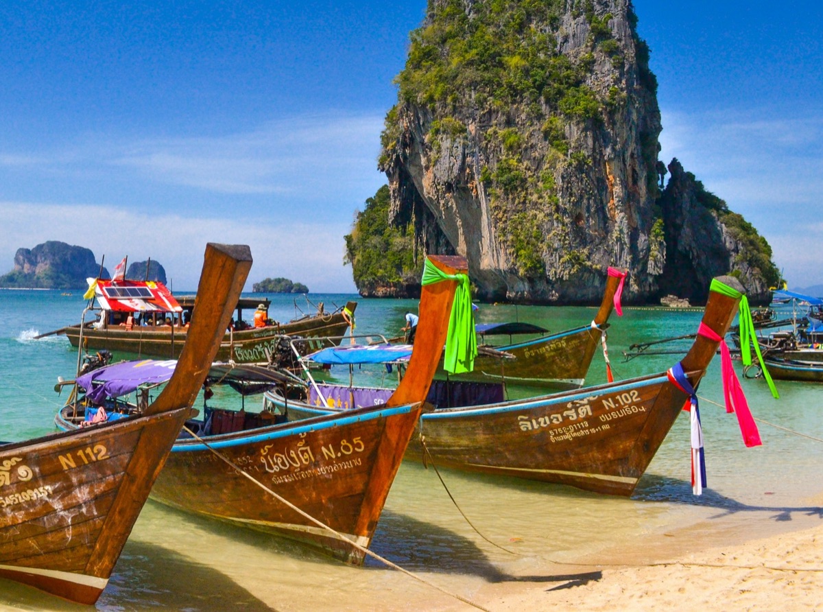 Traveler using phone on beach